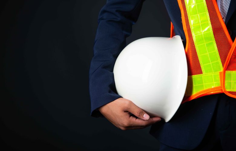 Portrait of a cheerful Young businessman construction site engineer,close up.